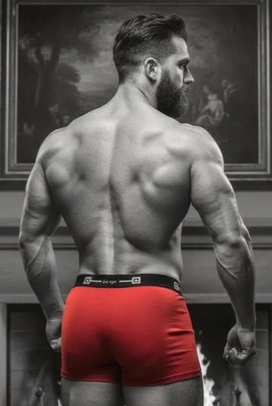 man standing in red boxershorts in bedroom